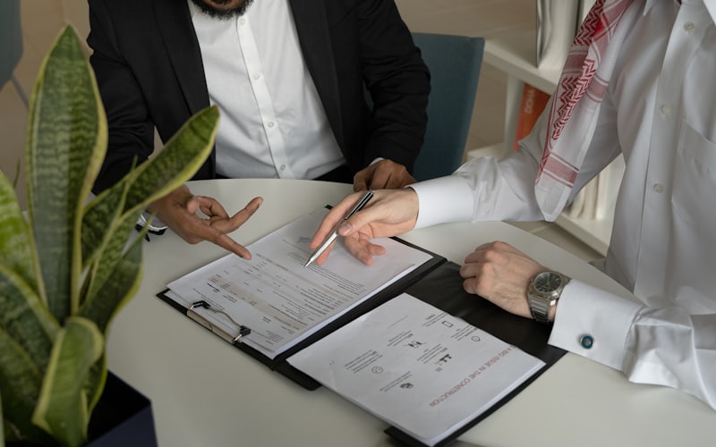 Signing a contract across a desk